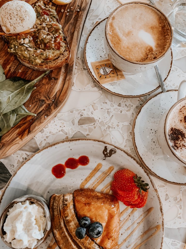 Brunch table flatlay - French toast, avo on toast, cofee