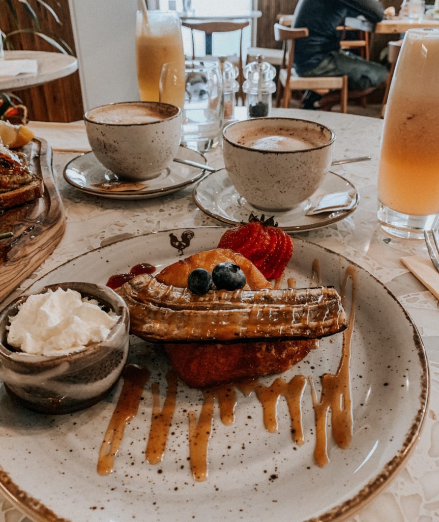 Our brunch table: baguette French toast, rum banana, fresh berries, out cappuccino, flat white, fresh juice